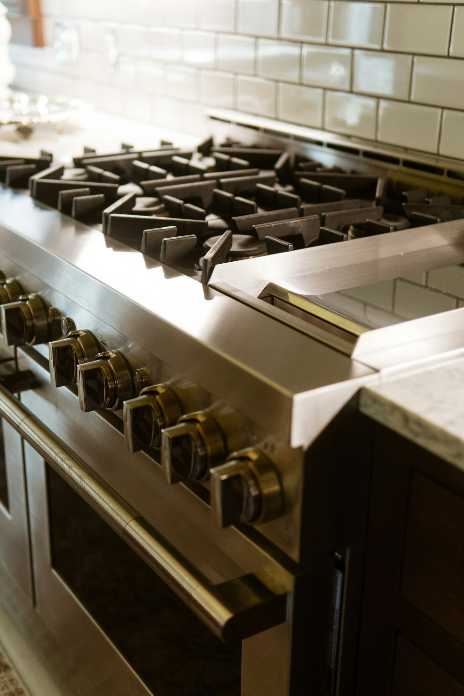 Close-up of a clean gas cooktop and stainless steel oven