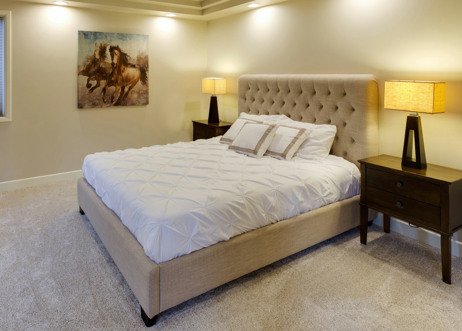 Neatly made bed with fresh white linen in soft light